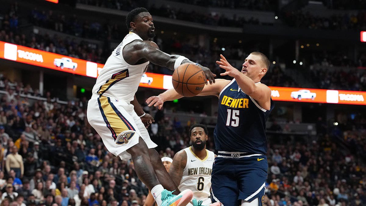 Zion Williamson blocks Nikola Jokić's shot during an NBA game in Denver.