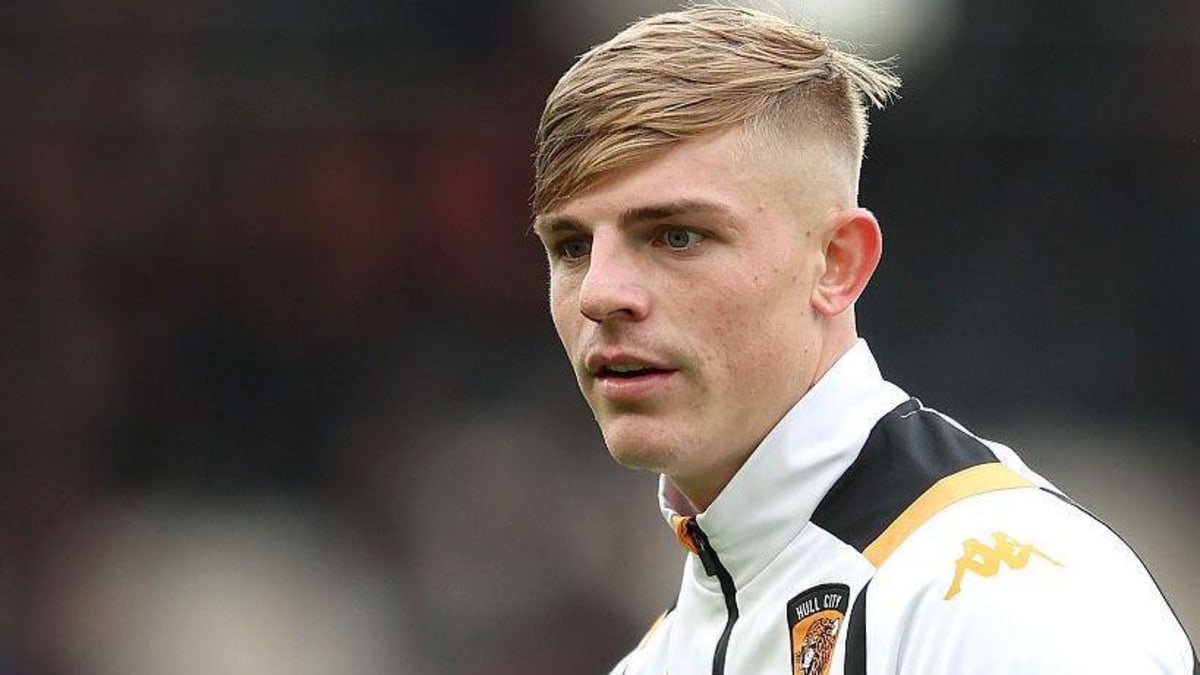 Brandon Williams in a white, black and amber Hull City training top