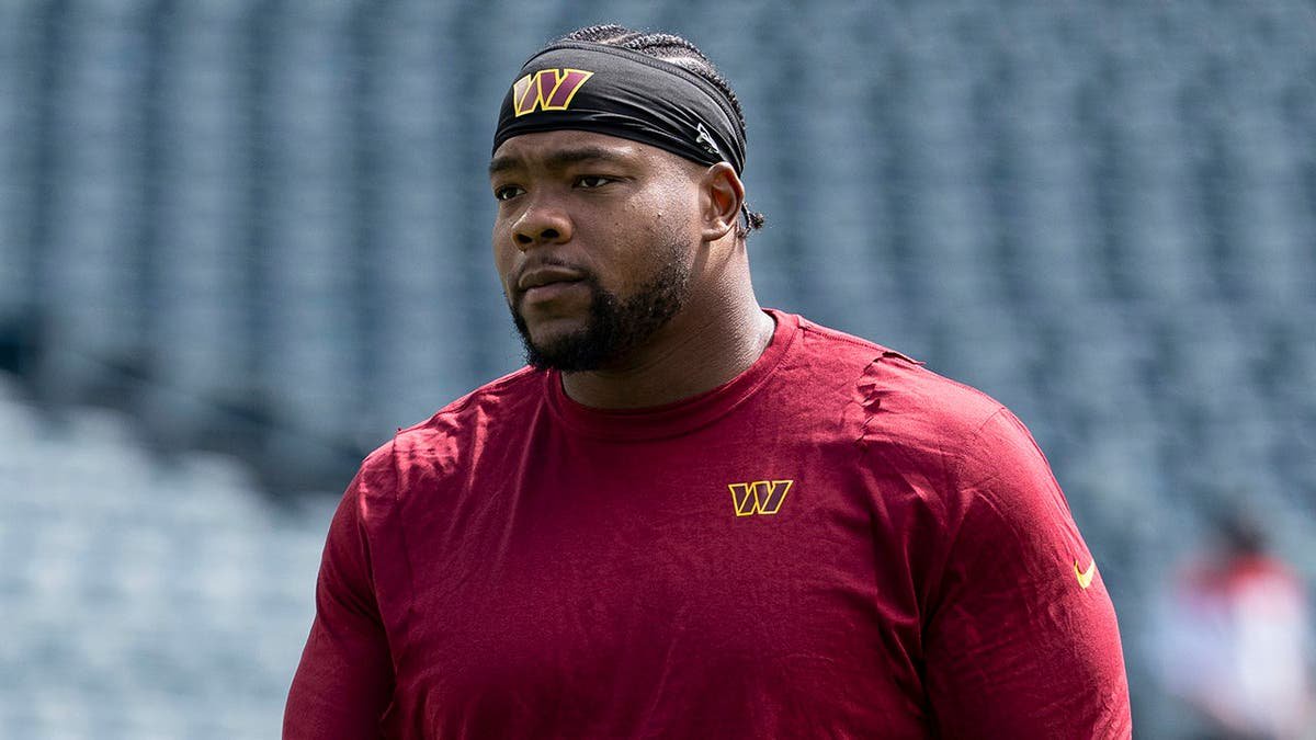 Daron Payne #94 of the Washington Commanders looks on before an NFL game.