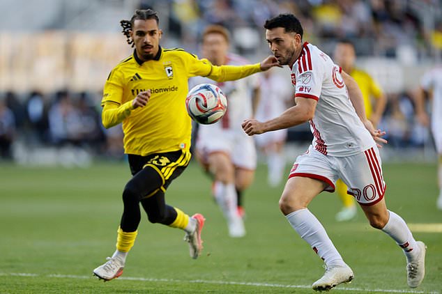 Toronto FC's Lewis Morgan, right, looks for an open shot as Columbus Crew's Mohamed Farsi defends during the first half of an MLS soccer match, Saturday, Oct. 24, 2026, in Columbus, Ohio. (AP Photo/Jay LaPrete)