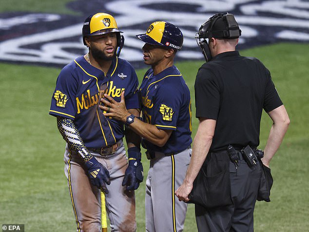 Milwaukee Brewers left fielder Jackson Chourio (L) argues with the umpire after striking out