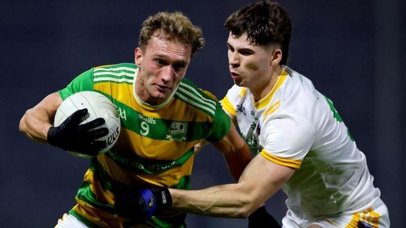 Edendork's Luke Ferguson is challenged by Senan Carr