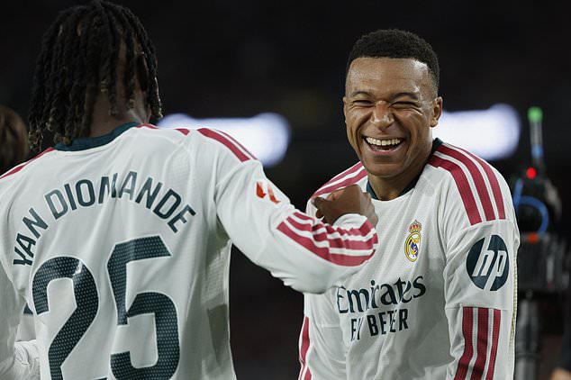 Real Madrid's Kylian Mbappe, right, celebrates after scoring his side's opening goal during a Spanish La Liga soccer match between FC Barcelona and Real Madrid in Barcelona, Spain, Sunday, Oct. 25, 2026. (AP Photo/Joan Monfort)