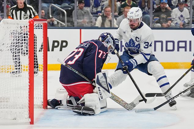 Columbus Blue Jackets goaltender Jet Greaves (73) blocks a shot by Toronto Maple Leafs center Auston Matthews (34) in the first period of an NHL hockey game in Columbus, Ohio, Tuesday, October. 20, 2026. (AP Photo/Sue Ogrocki)