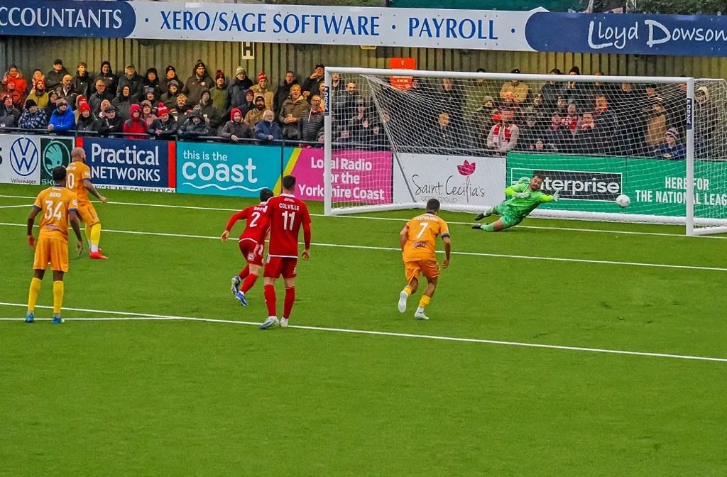 Moncur slots in another penalty at Scarborough, with the goalkeeper diving in vain.