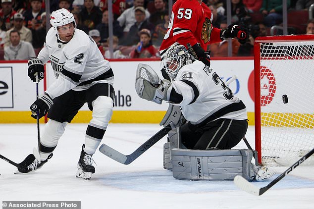 Los Angeles Kings goaltender Anton Forsberg (31) attempts to make a save against the Chicago Blackhawks as defenseman Brian Dumoulin (2) watches during the second period of an NHL hockey game, Tuesday, Oct. 27, 2026, in Chicago. (AP Photo/Jessie Alcheh)