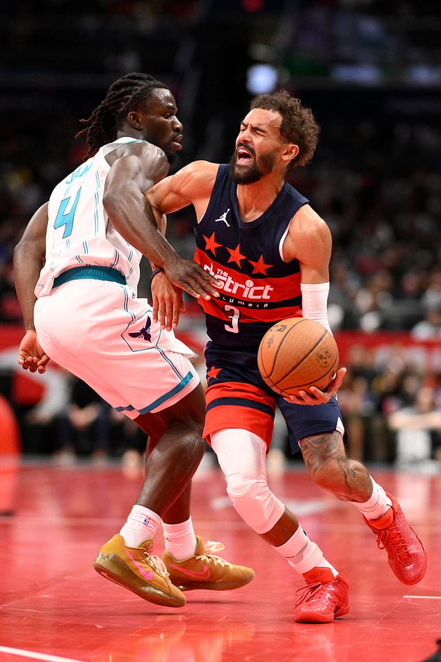 Washington Wizards guard Trae Young (3) is fouled by Charlotte Hornets guard Sion James (4) during the first half of an NBA Cup basketball game, Friday, Oct. 30, 2026, in Washington. (AP Photo/Nick Wass)