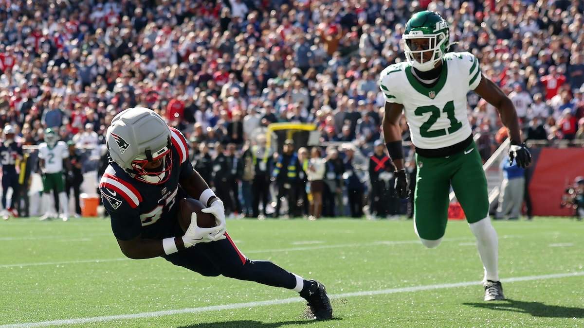 Romeo Doubs #87 of the New England Patriots scores a touchdown