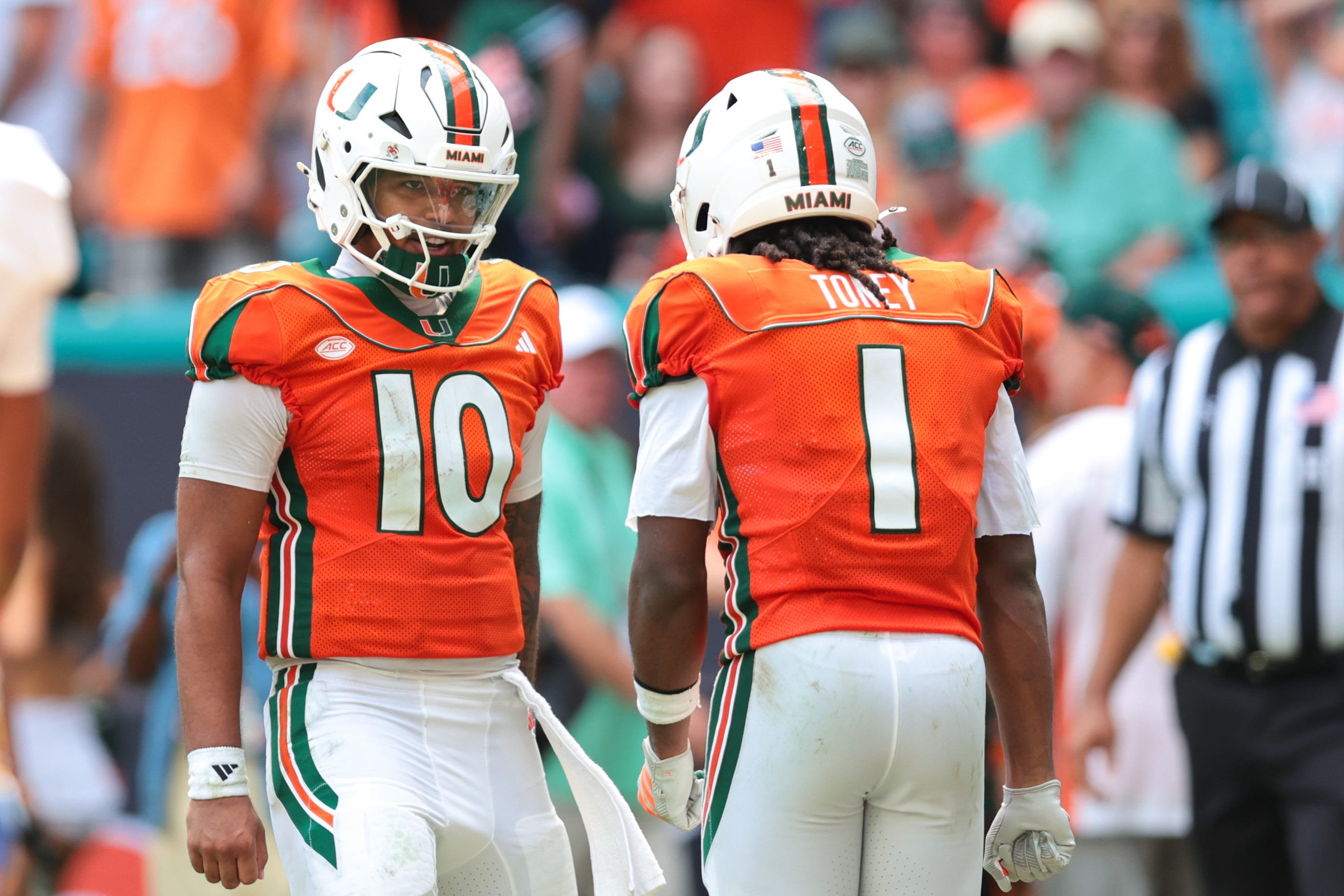 Miami Hurricanes wide receiver Malachi Toney (1) celebrates with quarterback Darian Mensah (10) 