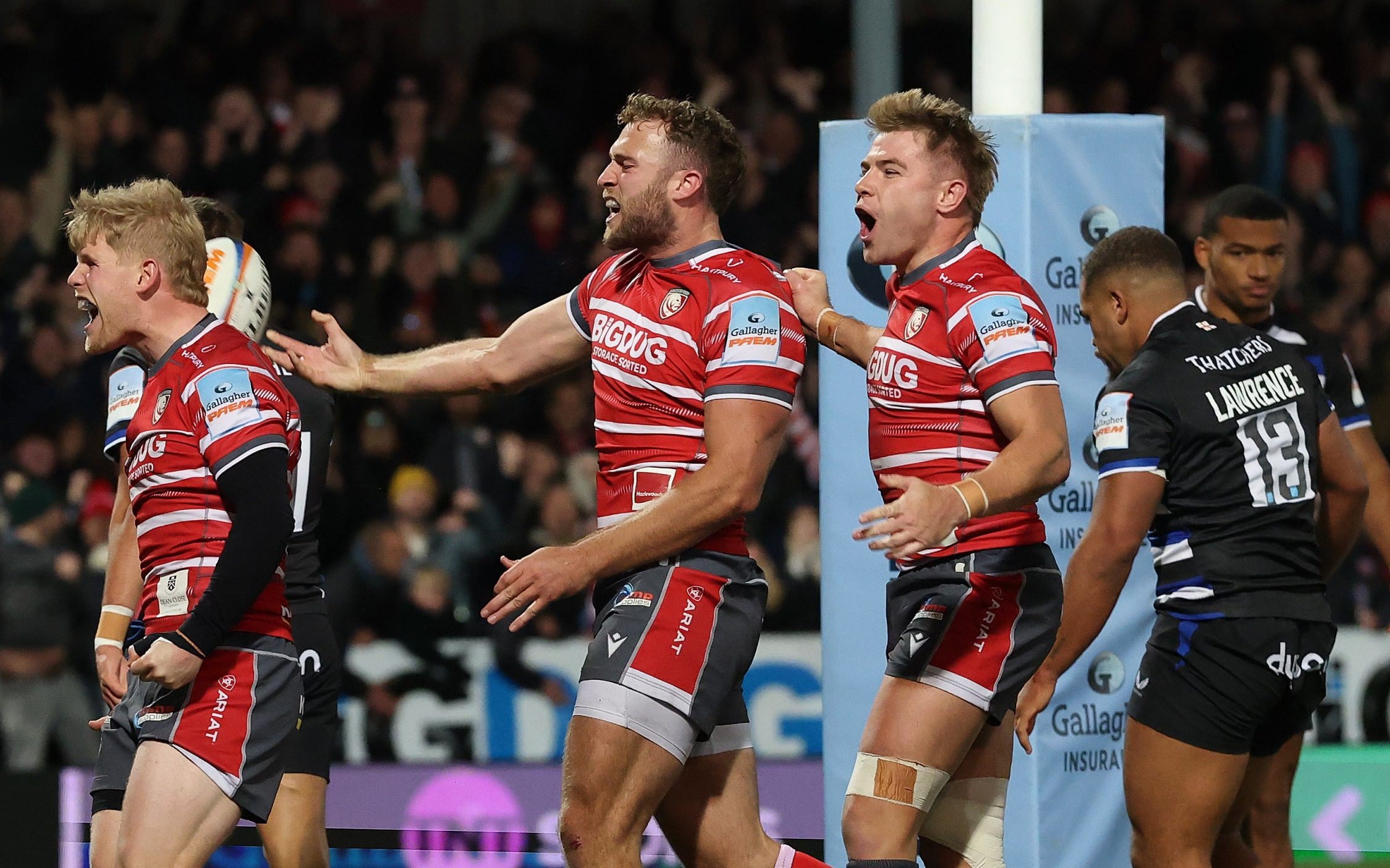 Max Llewellyn (centre) celebrates with team-mates George Barton (left) and Charlie Atkinson (right) after scoring their second try