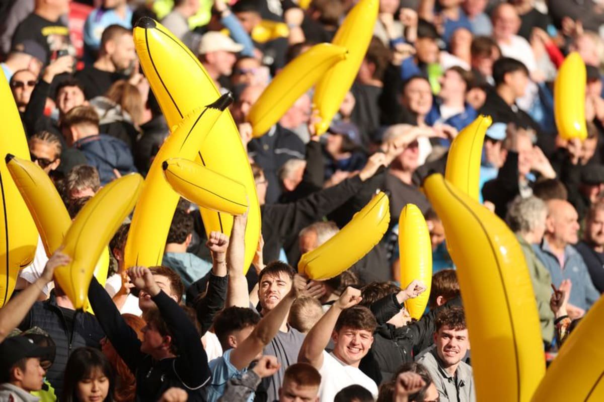 Manchester City fans hold up inflatable bananas towards Liverpool fans before the Premier League match between Liverpool FC and Manchester City at Anfield.
