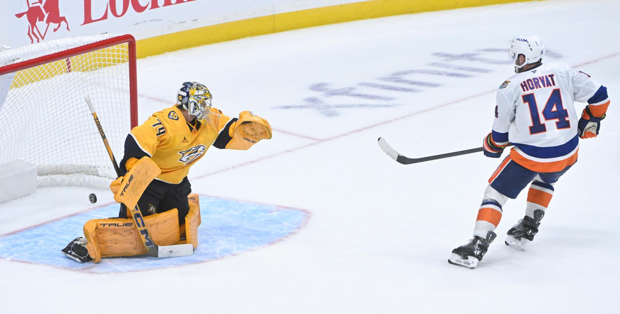 Bol Horvat scores on  a shootout goal on Juuse Saros during the Islanders' victory over the Predators. 