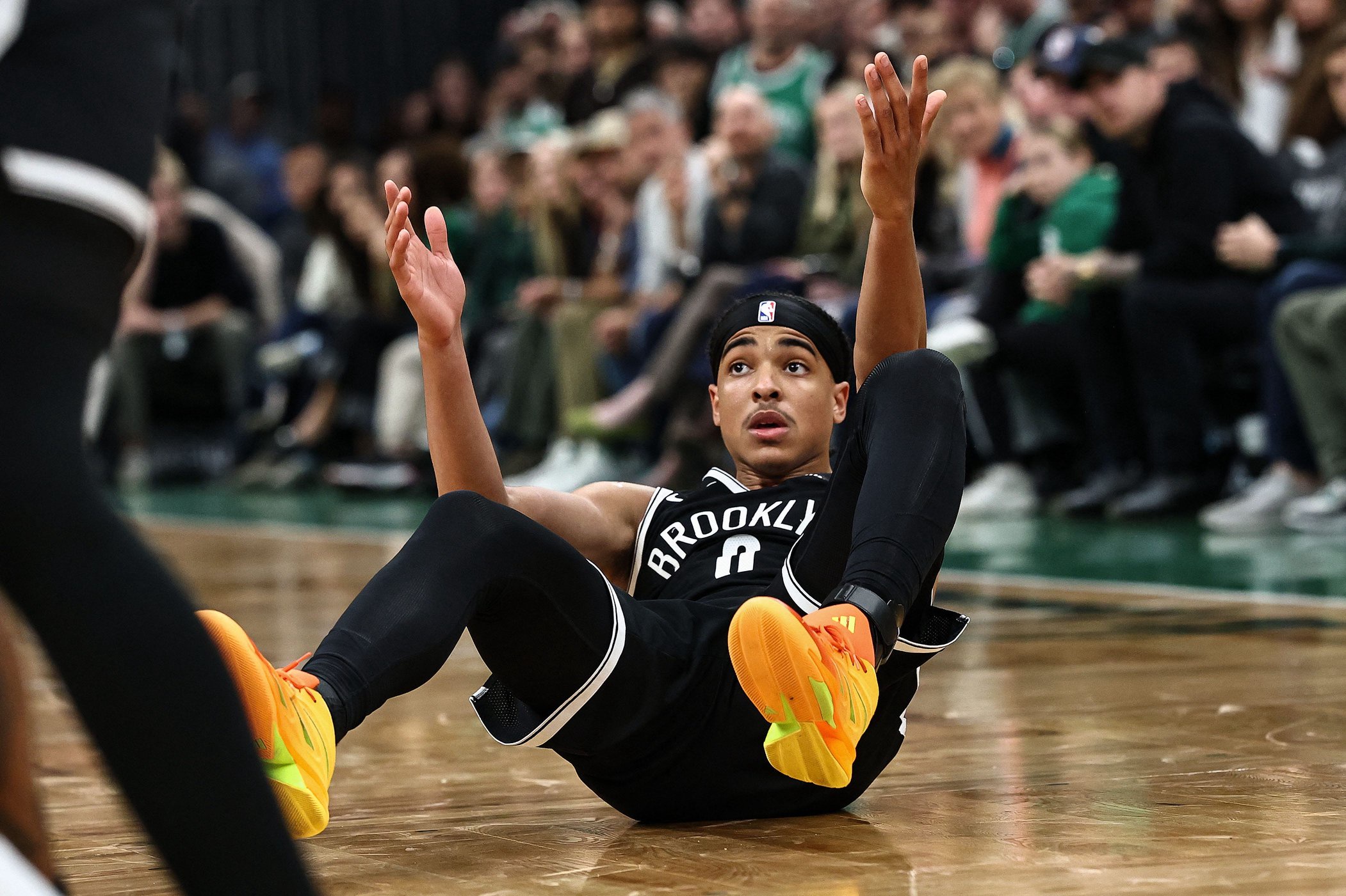 Oct 27, 2026; Boston, Massachusetts, USA; Brooklyn Nets guard Mikel Brown Jr. (0) sits on the floor after being knocked over on a missed three point attempt in overtime during their loss to the Boston Celtics at TD Garden. Mandatory Credit: Winslow Townson-Imagn Images