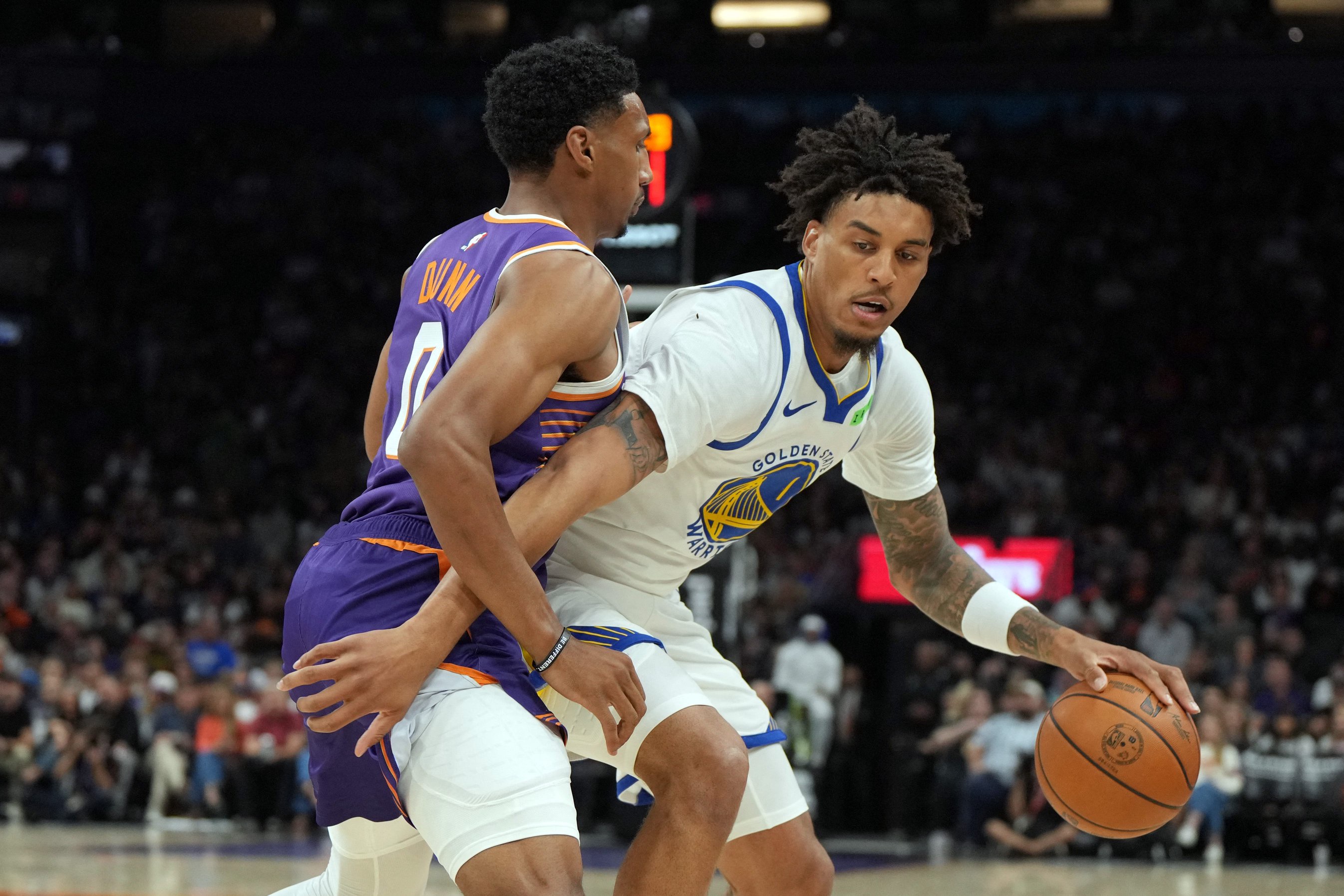 Oct 24, 2026; Phoenix, Arizona, USA;  Golden State Warriors forward Yaxel Lendeborg (1) shields the ball from Phoenix Suns forward Ryan Dunn (0) in the first half at Mortgage Matchup Center.  Mandatory Credit: Rick Scuteri-Imagn Images
