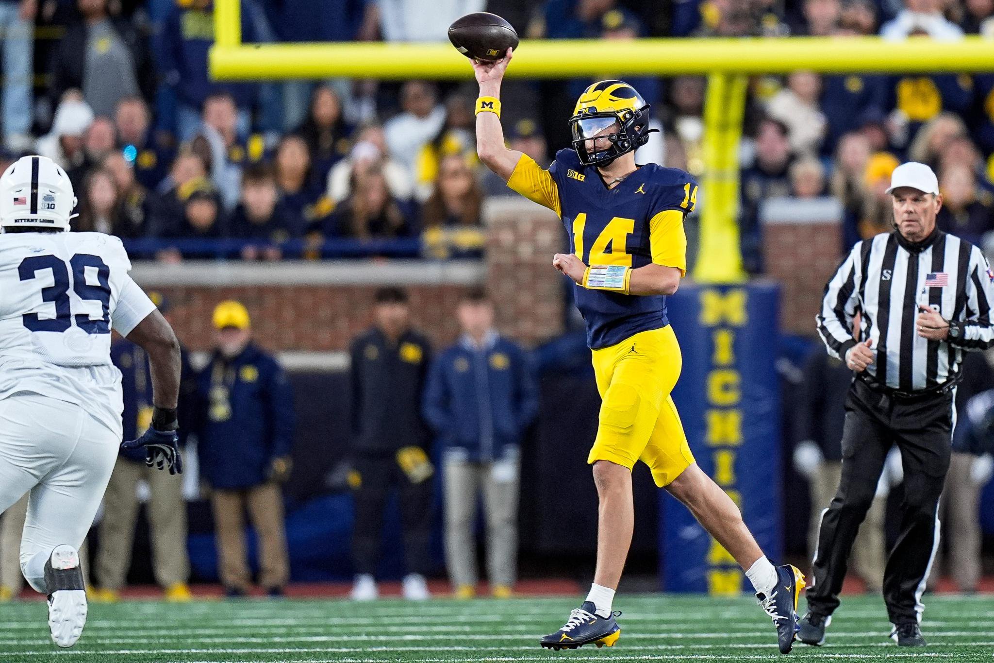 Michigan quarterback Tommy Carr (14) passes against Penn State during the second half at Michigan Stadium.