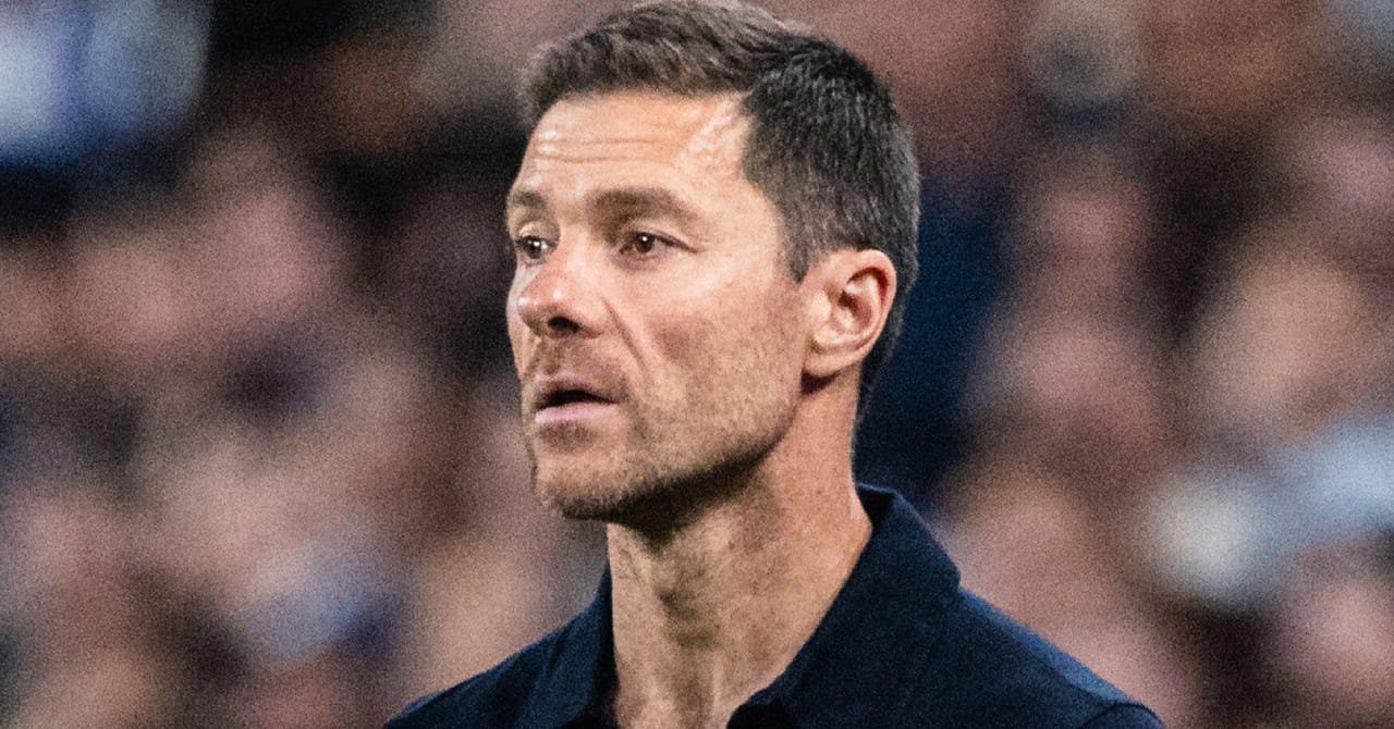 Football manager Xabi Alonso looking to his right while wearing a dark top in a stadium in his role as head coach of Premier League team Chelsea Football Club