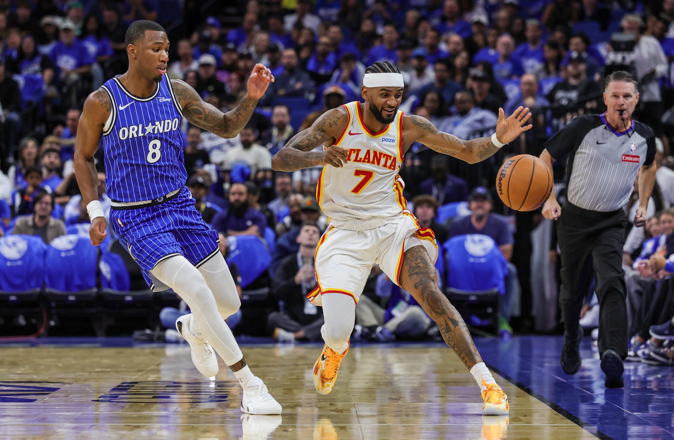 Oct 21, 2026; Orlando, Florida, USA;  Orlando Magic forward Jamal Cain (8) and Atlanta Hawks guard Nickeil Alexander-Walker (7) chase a loose ball during the second quarter at Kia Center.  Mandatory Credit: Mike Watters-Imagn Images