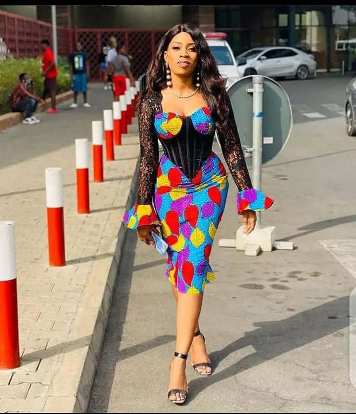 lady wearing ankara dress combined with net