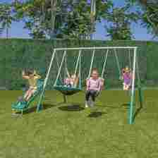 Kids playing on swing set on the grass