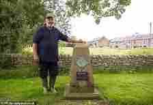 Mike Ashton stands next to the 'Peace Stone' in Nether Kellet, which was laid to mark that no one in the Lancashire village had died in the First or Second World Wars