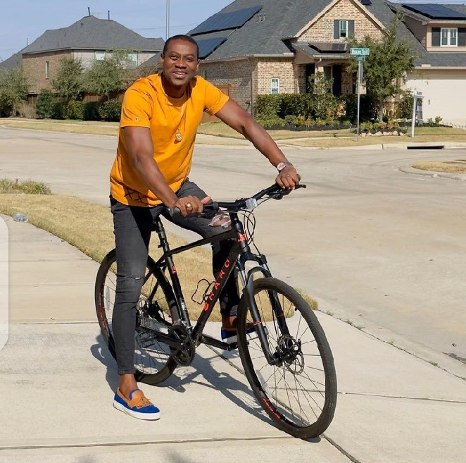 Actor Lateef Adedimeji rides bicycle on street of Texas during holiday season