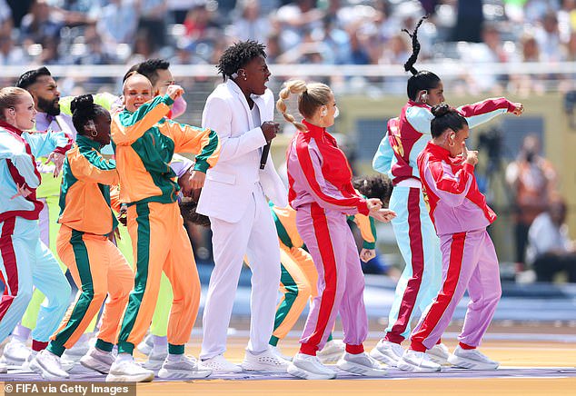 The content creator performed at MetLife Stadium amid a neon swarm of dancers