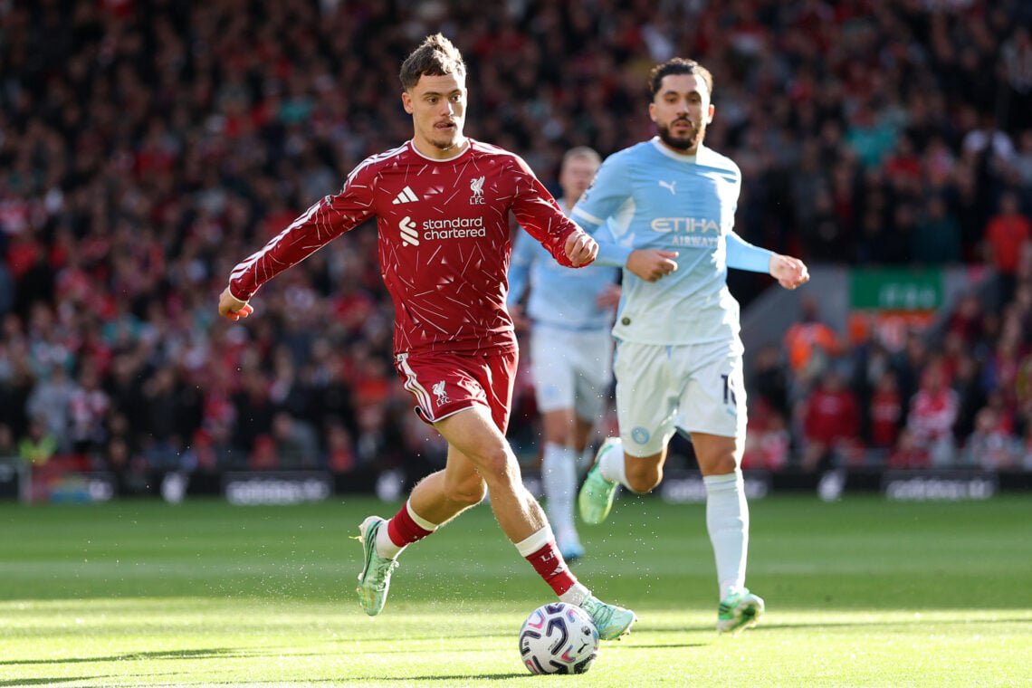 Florian Wirtz runs with the ball as Rayan Cherki looks on during Liverpool's Premier League match against Manchester City at Anfield