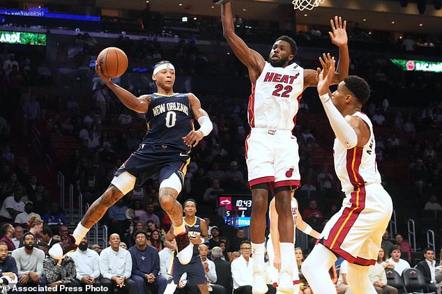 New Orleans Pelicans guard Jeremiah Fears (0) looks to pass the ball under pressure from Miami Heat forwards Andrew Wiggins (22) and Giannis Antetokounmpo (7) during the first half of an NBA preseason basketball game Thursday, Oct. 8, 2026, in Miami. (AP Photo/Marta Lavandier)