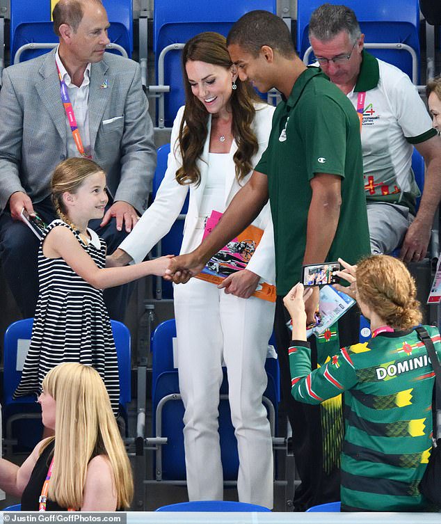The princess is starstruck as she shakes hands with Dominican swimmer Warren Lawrence