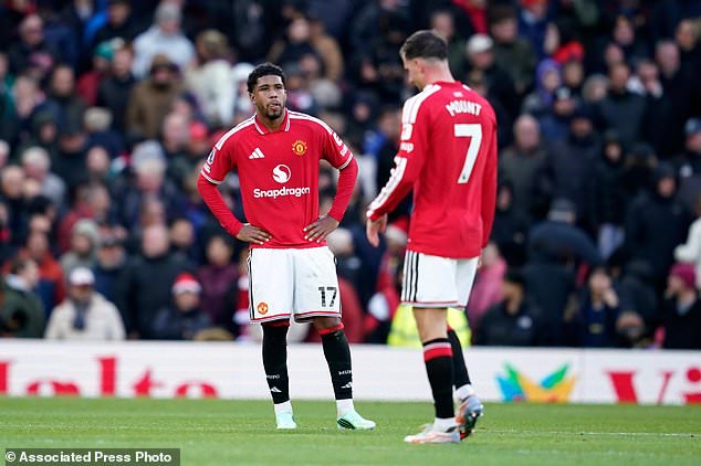 Manchester United's Andrey Santos, left, and Manchester United's Mason Mount react during the English Premier League soccer match between Manchester United and Bournemouth in Manchester, England, Sunday, Oct. 25, 2026. (AP Photo/Dave Thompson)