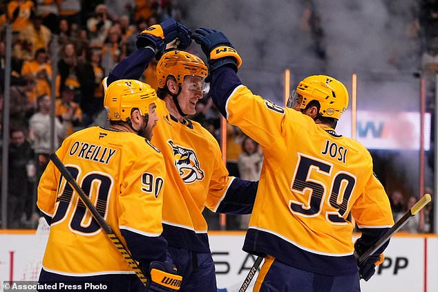 Nashville Predators center Adam Edstrom, middle, celebrates his goal with Ryan O'Reilly (90) and Roman Josi (59) during the second period of an NHL hockey game against the St. Louis Blues, Saturday, Oct. 17, 2026, in Nashville, Tenn. (AP Photo/George Walker IV)
