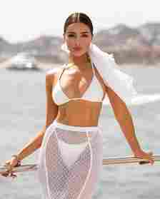 Olivia Culpo wearing a bikini by the ocean