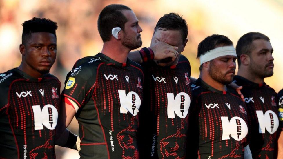 Lions players are emotional during a minute's silence for late team-mate Hyron Andrews