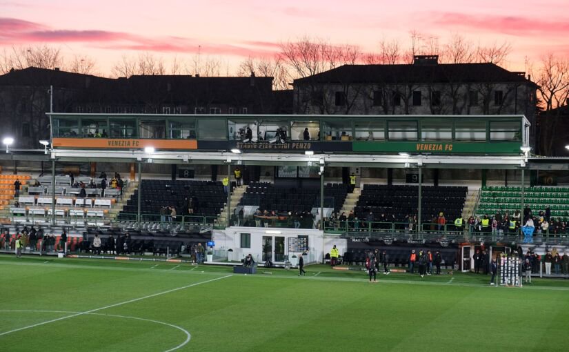 Main stand of Venezia's Stadio Pier Luigi Penzo at dusk under a pink sky