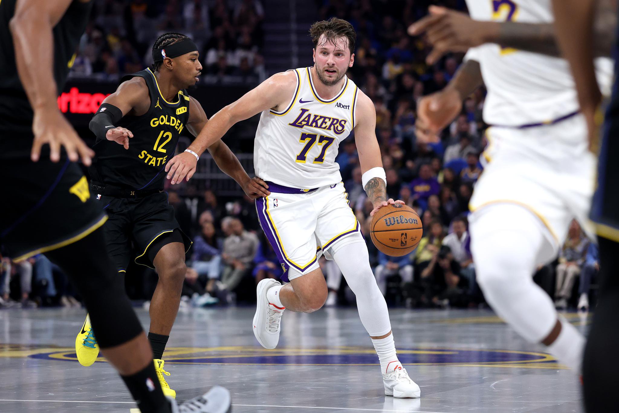 Luka Doncic dribbles the ball down the court during a game between the Los Angeles Lakers and Golden State Warriors.