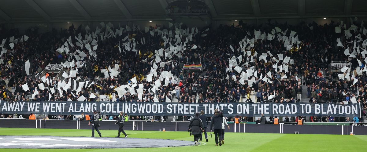 A banner with a line from The Blaydon Races song held up by Newcastle United fans