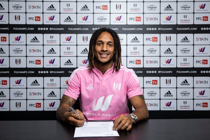 Kevin Mbabu signs his Fulham contract.
