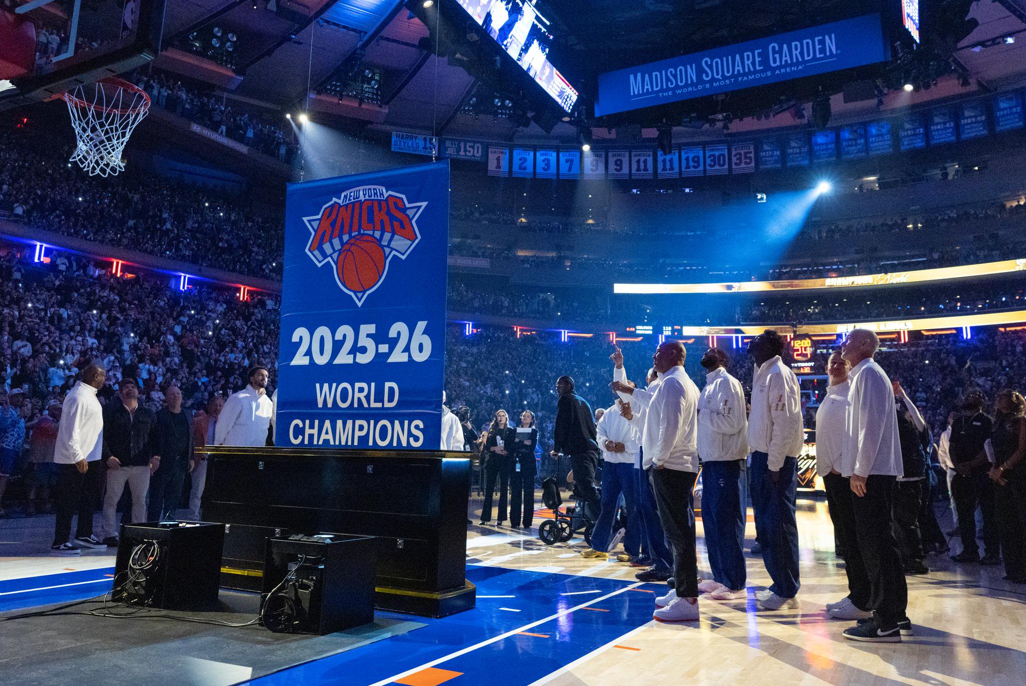 The 2026 NBA final champions watch as they hoist the Championship Banner to the rafters before the start of the first quarter.