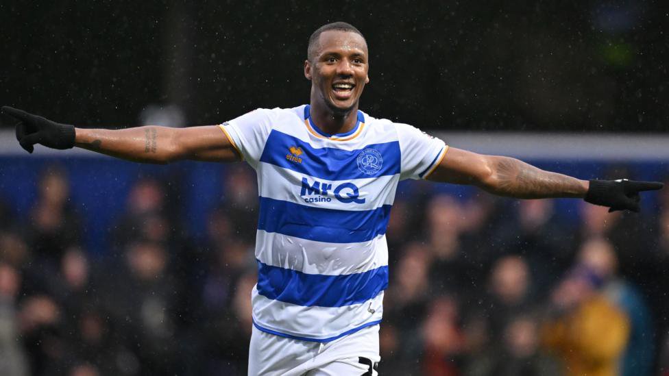 Richard Kone celebrates a goal against Swansea with arms outstretched and gloves on his hands