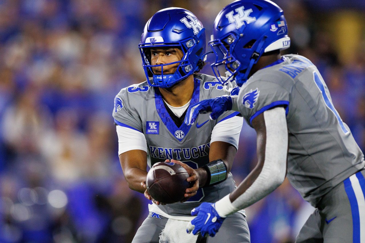 Oct 24, 2026; Lexington, Kentucky, USA;  Kentucky Wildcats quarterback Kenny Minchey (3) hands the ball to Kentucky Wildcats running back CJ Baxter (1) during the first quarter against the Vanderbilt Commodores at Kroger Field.  Mandatory Credit: Jordan Prather-Imagn Images