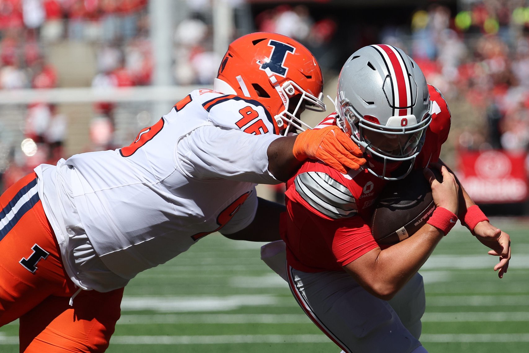 Sep 26, 2026; Columbus, Ohio, USA;  Ohio State Buckeyes quarterback Julian Sayin (10) scores a rushing touchdown as Illinois Fighting Illini defensive line Darrell Prater (96) defends during the first half at Ohio Stadium.  Mandatory Credit: Joseph Maiorana-Imagn Images