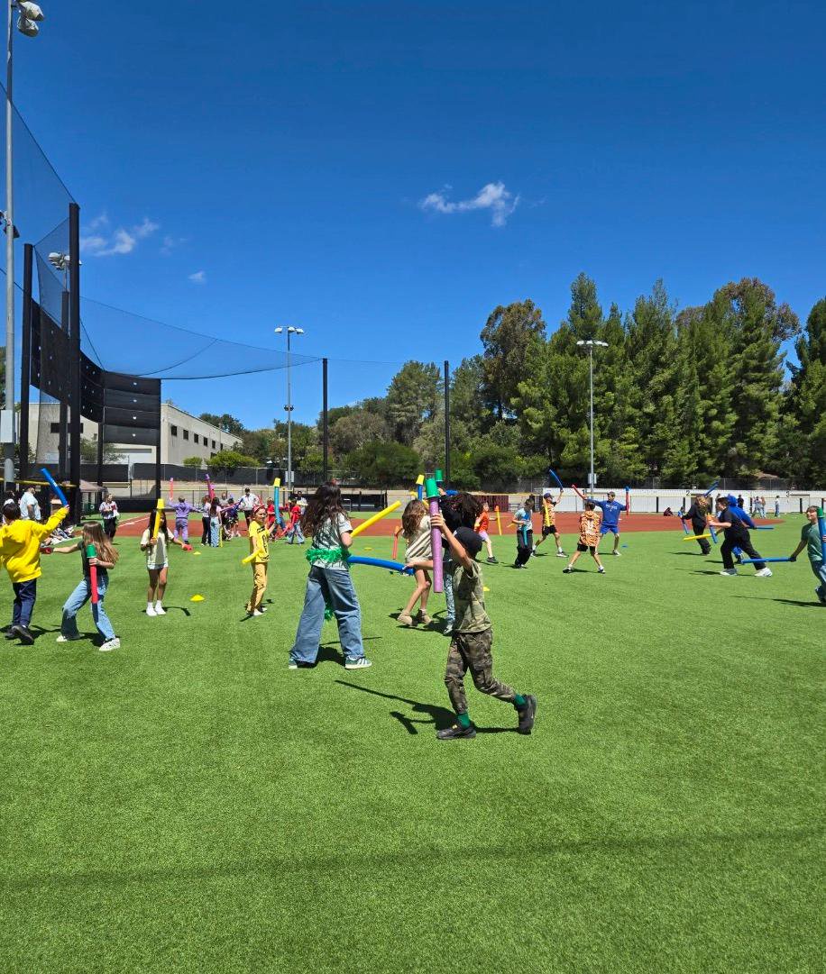 A group of students play on the artificial turf field at Oaks Christian School.