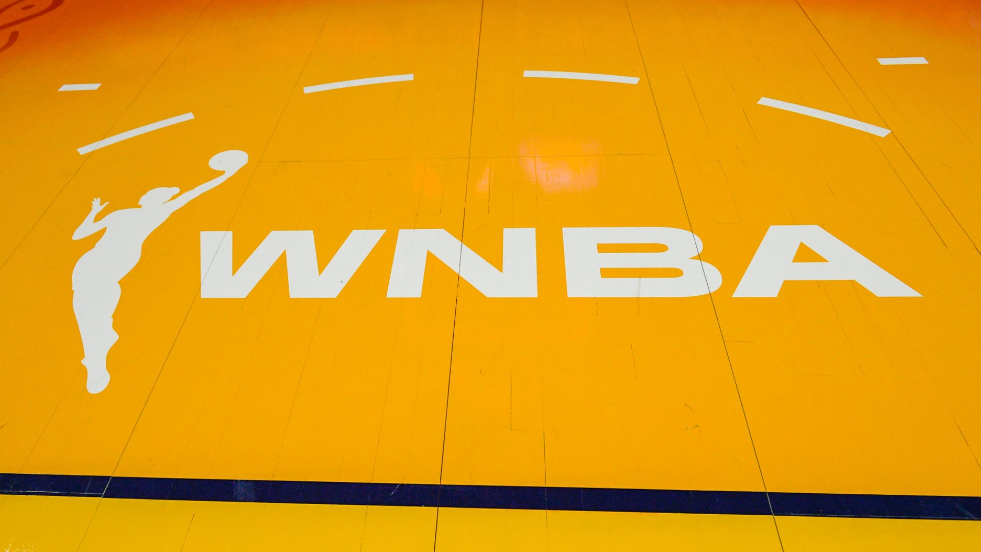 WNBA logo on a basketball court with a yellow background and white silhouette of a player.