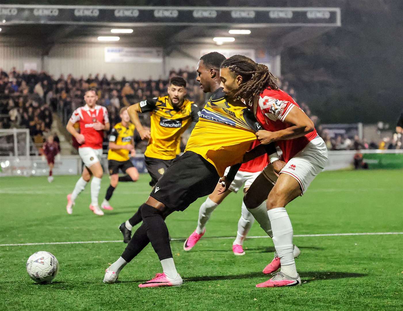 Ebbsfleet defender Cameron Gbadebo gets to grips with Ken Charles in the box. Picture: Helen Cooper