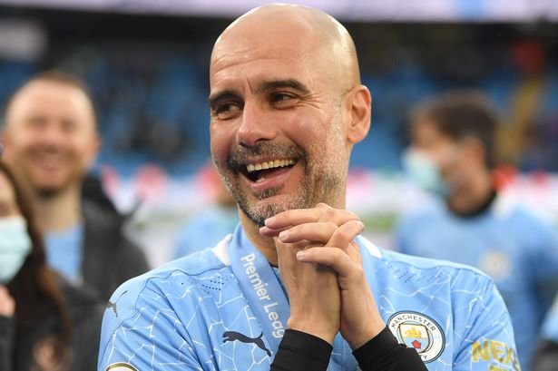 Pep Guardiola, Manager of Manchester City reacts after Manchester City are presented with the Premier League Trophy as they win the league following the Premier League match between Manchester City and Everton at Etihad Stadium on May 23, 2021 in Manchester, England.