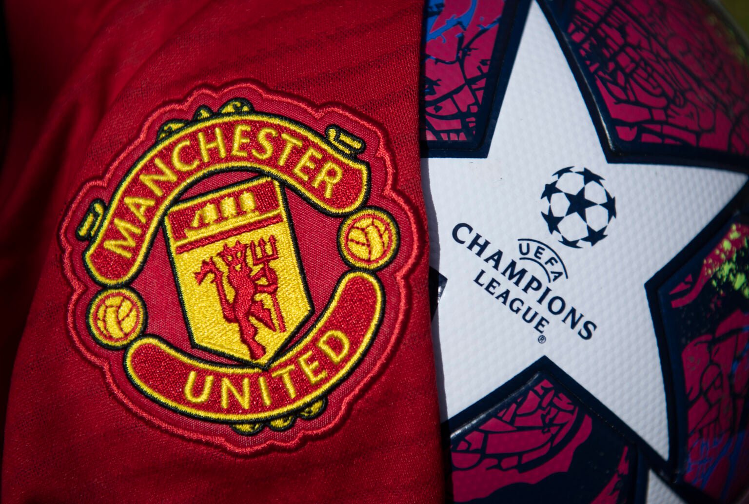The Manchester United Club Crest with a Champions League Match Ball