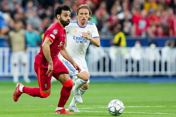 Luka Modric of Real Madrid CF and Mohamed Salah of Liverpool FC compete for the ball during the UEFA Champions League Final match between Liverpool FC and Real Madrid CF at Stade de France on May 28, 2022 in Paris, France.