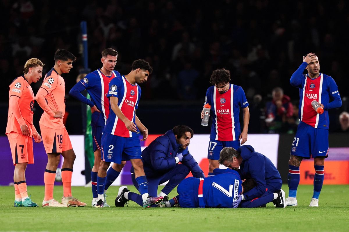 Khvicha Kvaratskhelia lies on the pitch after sustaining an injury during the UEFA Champions League first round day 3 football match between Paris Saint Germain (PSG) and FC Barcelona. 