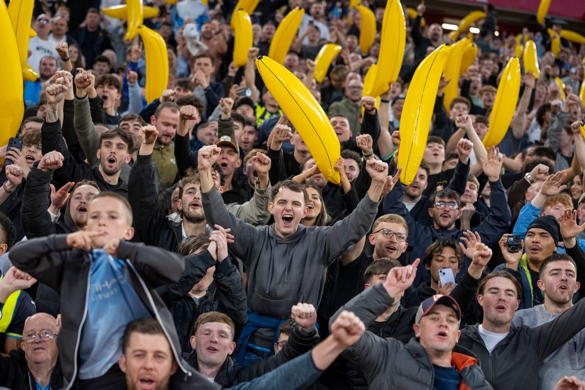 Manchester City fans celebrate with inflatable bananas in the stands during the Premier League 2026/27 match between Liverpool FC and Manchester City at Anfield