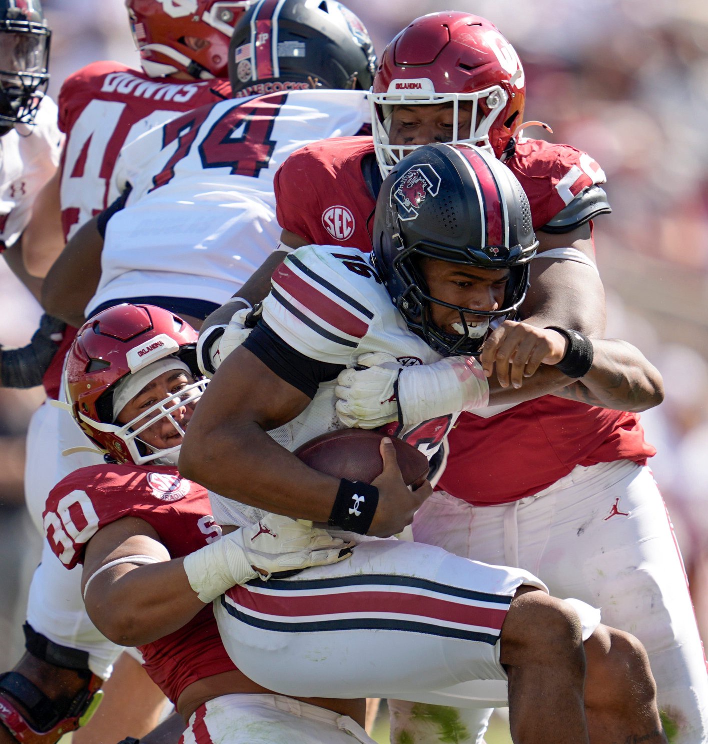 Oklahoma Sooners defensive lineman Trace Ford (30) and Oklahoma Sooners defensive lineman Gracen Halton (56) bring down South Carolina Gamecocks quarterback LaNorris Sellers (16) during a college football game between the University of Oklahoma Sooners (OU) and the South Carolina Gamecocks at Gaylord Family - Oklahoma Memorial Stadium in Norman, Okla., Saturday, Oct. 19, 2024.